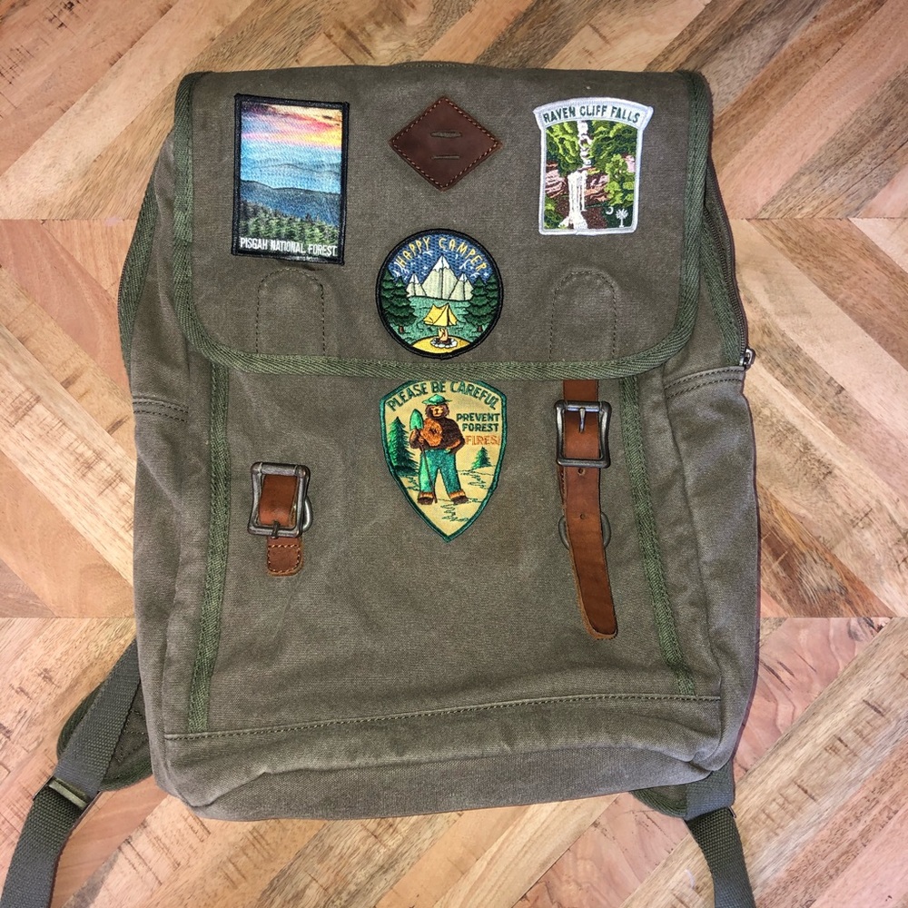 Green canvas day pack with table patches